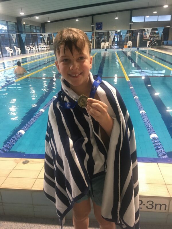 Receiving Swordy 1km swim medal